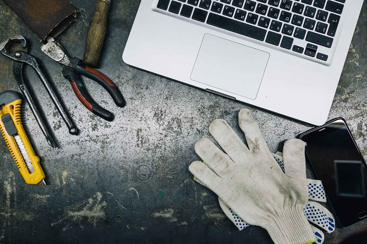 top-view-of-old-tools-laptop-and-phone-on-table-720